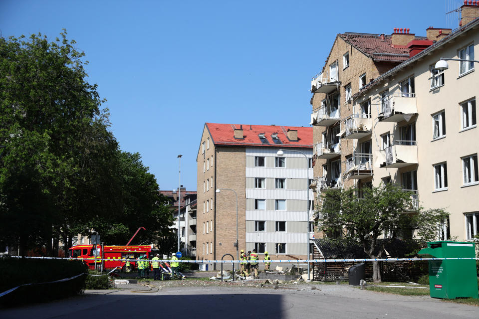 Rescue personnel outside a block of flats that were hit by an explosion, in Linkoping, Sweden, Friday, June 7, 2019. A blast ripped through two adjacent apartment buildings in a southern Sweden city on Friday, police said. There were unconfirmed reports of people with minor injuries. (Jeppe Gustafsson/TT News Agency via AP)