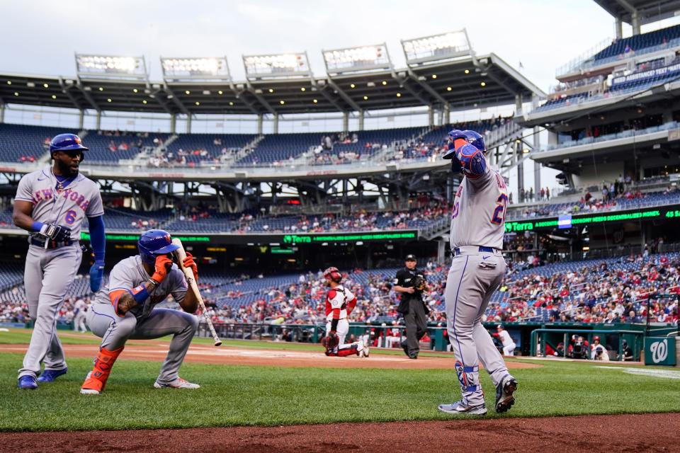 New York Mets designated hitter Pete Alonso, right, celebrates his two-run homer with Starling Marte, left, and Dominic Smith during the first inning of a baseball game against the Washington Nationals at Nationals Park, Wednesday, May 11, 2022, in Washington.