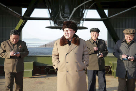 Kim Jong Un smiles as he visits Sohae Space Center in Cholsan County, North Pyongan province for the testing of a new engine for an intercontinental ballistic missile (ICBM) in this undated photo released April 9, 2016. KCNA/via REUTERS