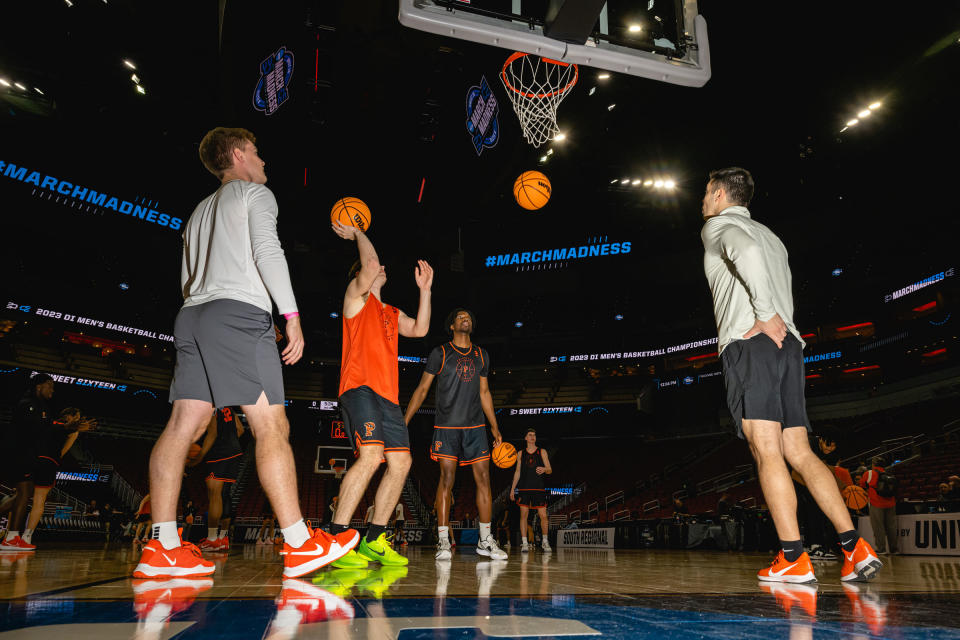 Ryan Langborg and Leyi Adebayo put up shots during open practice at the KFC Yum! Center in Louisville, Ky., on March 23, 2023.<span class="copyright">Jon Cherry for TIME</span>