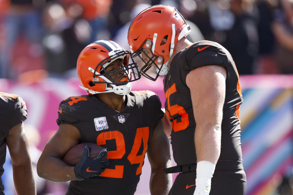 Cleveland Browns running back Nick Chubb (24) celebrates with center Ethan Pocic (55) after a touchdown run during the first half of an NFL football game, Sunday, Oct. 9, 2022, in Cleveland. (AP Photo/Ron Schwane)