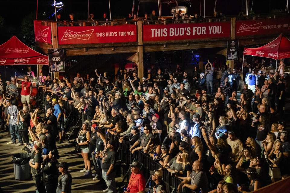 FILE - In this Friday, Aug. 14, 2020, file photo fans attend a performance by Saul at the Iron Horse Saloon during the 80th annual Sturgis Motorcycle Rally, in Sturgis, S.D. Health officials across five states have linked 178 virus cases to the Sturgis Motorcycle Rally. In the three weeks since the rally kicked off, coronavirus cases in South Dakota have shot up at a startling pace. (Amy Harris/Invision/AP, File)