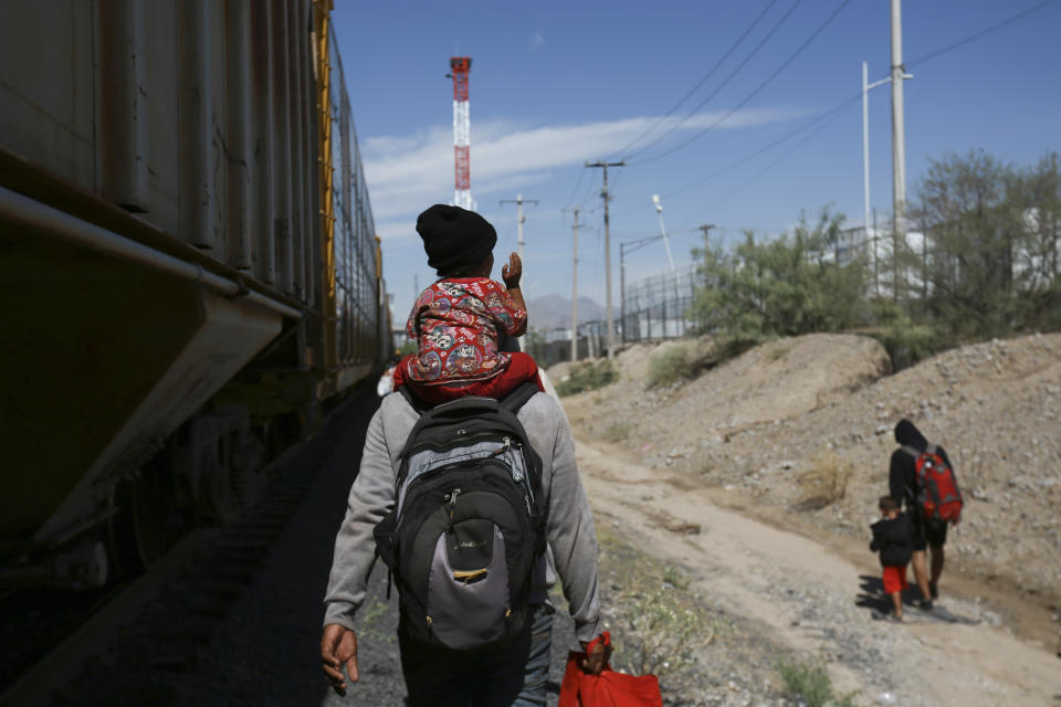 Migrants walk beside a freight train that brought them to Ciudad Juarez, Mexico, Thursday, Sept. 28, 2023. (AP Photo/Christian Chavez)