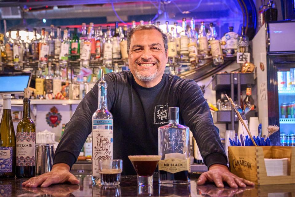 Francisco Peralta presents an espresso agave martini and most of the ingredients used to make it on El Charro Hipster Bar and Cafe's bar in Phoenix on Friday, Jan. 28, 2023.