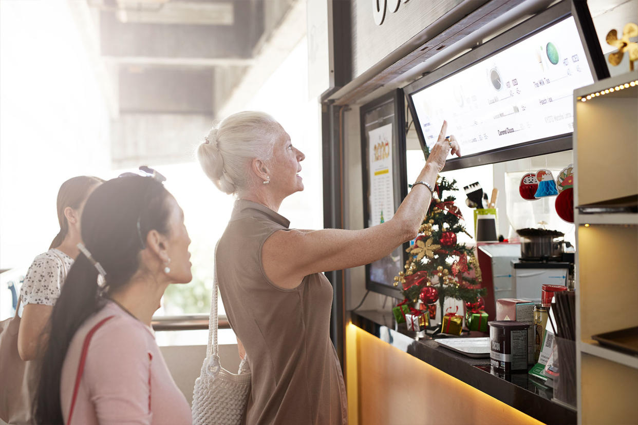Senior woman ordering at fast food restaurant Getty Images/Klaus Vedfelt