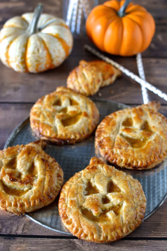 <p>These jack-o'-lantern pumpkin hand pies are mini, portable and oh so cute, made from pumpkin pie wrapped in a portable pie crust.</p><p><strong>Get the recipe: <a href="http://www.sprinkledwithjules.com/home/2014/10/5/jack-o-lantern-pumpkin-hand-pies" rel="nofollow noopener" target="_blank" data-ylk="slk:Jack-O'-Lantern Pumpkin Hand Pies;elm:context_link;itc:0;sec:content-canvas" class="link ">Jack-O'-Lantern Pumpkin Hand Pies</a></strong></p>