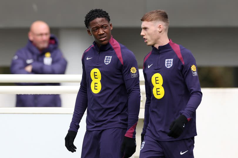 Kobbie Mainoo and Cole Palmer of England talk during a training session.