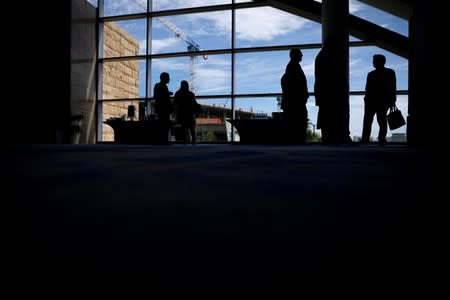 FILE PHOTO: People arrive to attend a meeting of the Finantial Oversight and Management board for Puerto Rico, a year after Hurricane Maria devastated Puerto Rico in San Juan, Puerto Rico