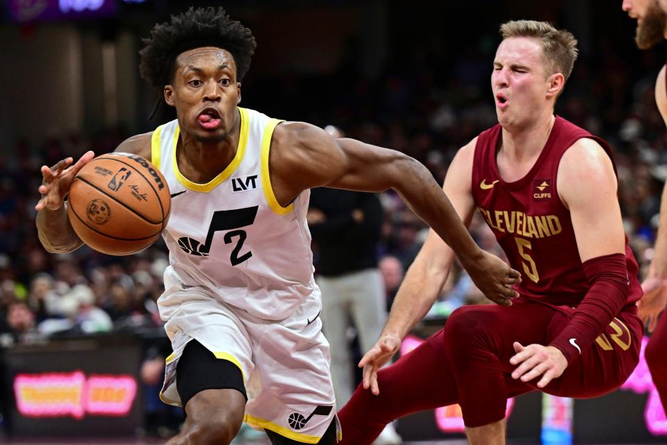 Utah Jazz guard Collin Sexton drives on Cleveland Cavaliers guard Sam Merrill during the second half Wednesday in Cleveland.
