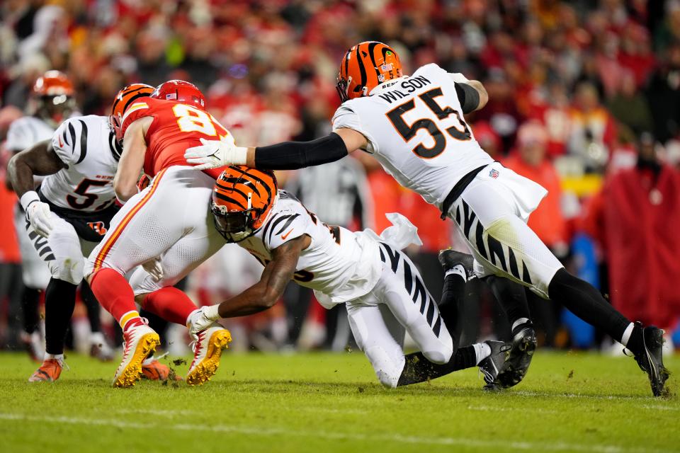 Cincinnati Bengals safety Dax Hill (23) tackles Kansas City Chiefs tight end Travis Kelce (87) in the third quarter during a Week 17 NFL football game between the Cincinnati Bengals and the Kansas City Chiefs, Sunday, Dec. 31, 2023, at GEHA Field at Arrowhead Stadium in Kansas City, Mo. The Kansas City Chiefs won, 25-17.