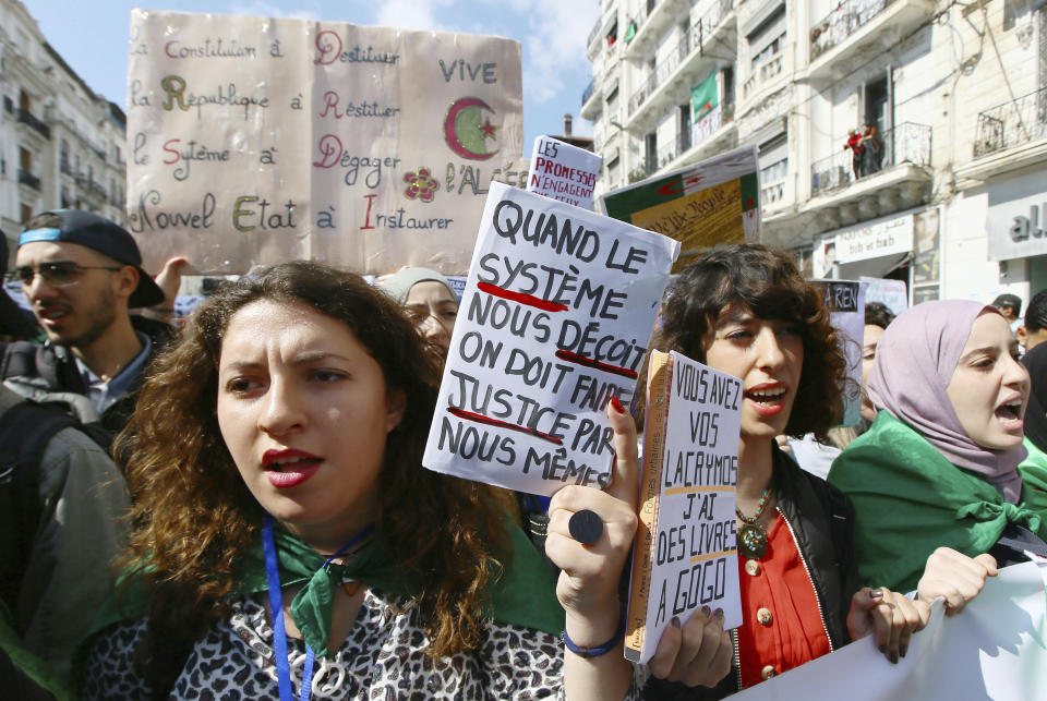 Algerian students march during a protest in Algiers, Algeria, Tuesday, April 2, 2019. Algerian protesters and political leaders are expressing concerns that ailing President Abdelaziz Bouteflika's departure will leave the country's secretive, distrusted power structure in place. Placard, center, reads, "when the system fails we have to make justice by ourselves". (AP Photo/Anis Belghoul)