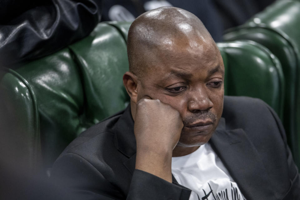 Patrick Lyoya's father, Peter Lyoya, reacts during the funeral for his son, Patrick Lyoya at the Renaissance Church of God in Christ Family Life Center in Grand Rapids, Mich. on Friday, April 22, 2022. The Rev. Al Sharpton demanded that authorities publicly identify the Michigan officer who killed Patrick Lyoya, a Black man and native of Congo who was fatally shot in the back of the head after a struggle, saying at Lyoya's funeral Friday: “We want his name!" (Cory Morse/The Grand Rapids Press via AP)