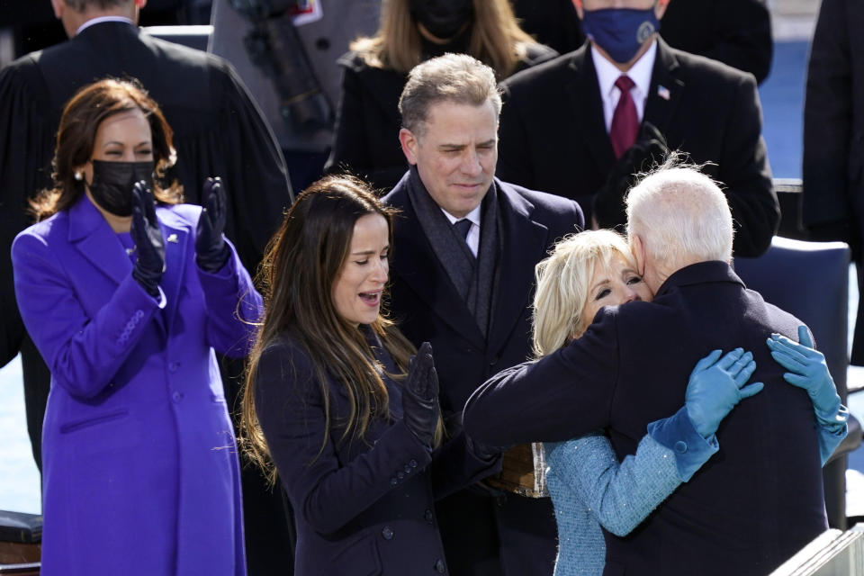 FILE - In this Wednesday, Jan. 20, 2021, file photo, President Joe Biden hugs first lady Jill Biden, as his son Hunter Biden and daughter Ashley Biden look on after the president was sworn-in during the 59th presidential inauguration at the U.S. Capitol in Washington. Vice President Kamala Harris applauds, at left. Hunter Biden says his service on the board of a Ukrainian gas company wasn't unethical and didn't amount to a lack of judgment on his part. But he writes in a new book, “Beautiful Things,” that he wouldn't do it again, citing partisan politics as the reason. (AP Photo/Carolyn Kaster, File)