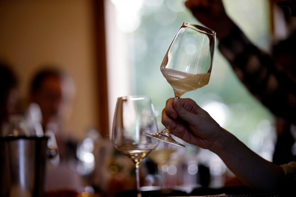 In this image taken on Monday, Oct. 15, 2018, an expert wine tester shakes a glass of Prosecco during a wine testing at the Case Paolin farm, in Volpago del Montello, Italy. Prosecco has become the best-selling sparkling wine in the world, and experts say it is eroding the more casual corner of champagne's market while aiming higher. Its production eclipsed champagne's five years ago and is now 75 percent higher at 544,000 bottles three-quarters of which for export.0 bottles three-quarters of which for export.(AP Photo/Luca Bruno)