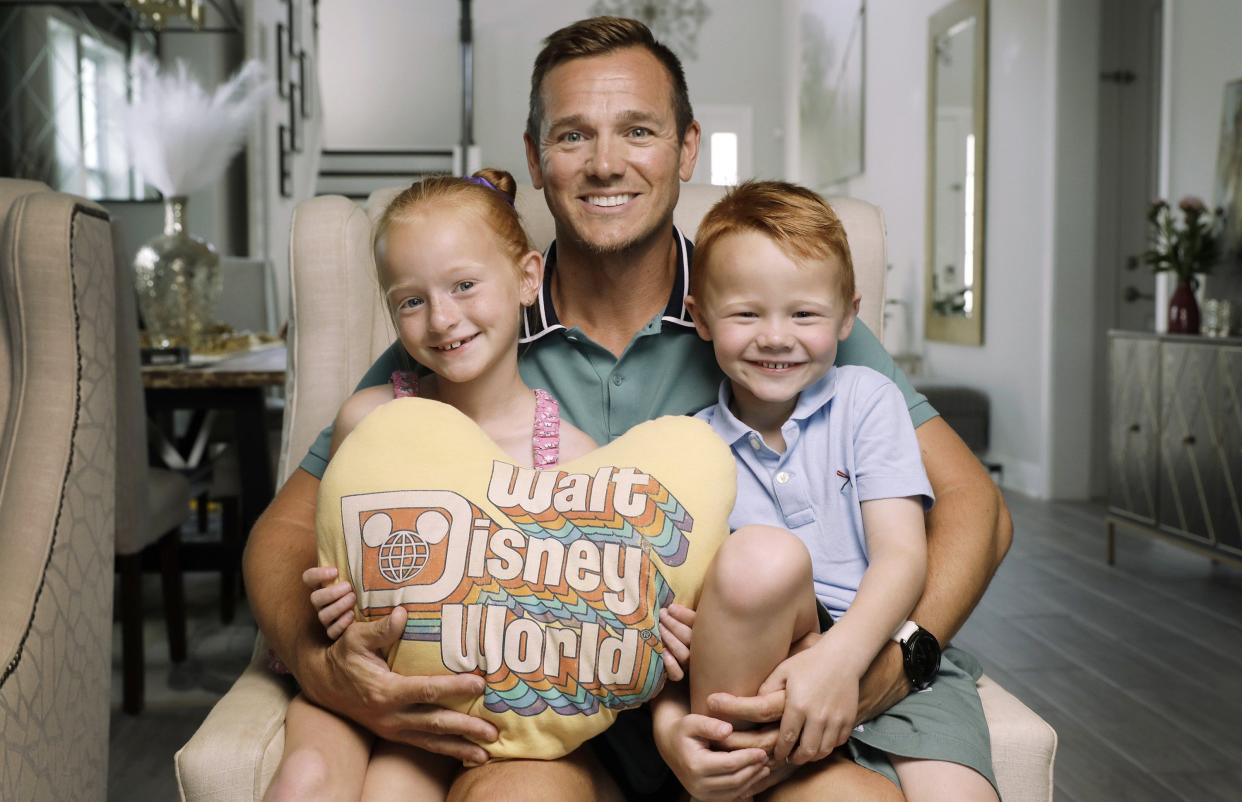 Nick Rotondi with daughter Chloe, 6, and son Cole, 4, hold a pillow made by a Community Hospice volunteer to honor Rotondi's father, Salvatore, who died in April. More than 100 pillows have been made by a dozen or so volunteer sewers in the past year.