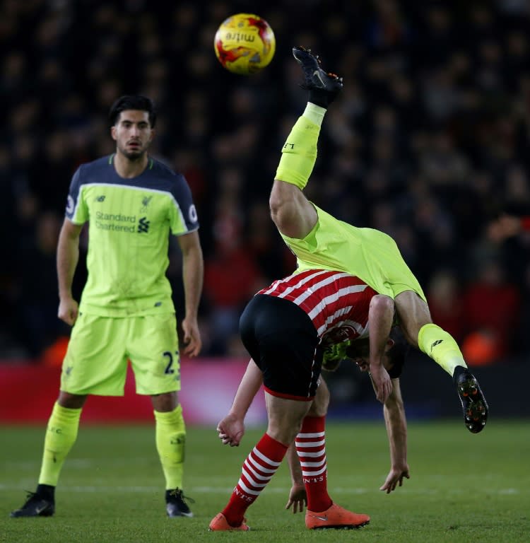 Liverpool's Emre Can (L) waches as Ragnar Klavan collides with Southampton's Shane Long during their League Cup semi-final first leg at St Mary's Stadium in Southampton, southern England on January 11, 2017