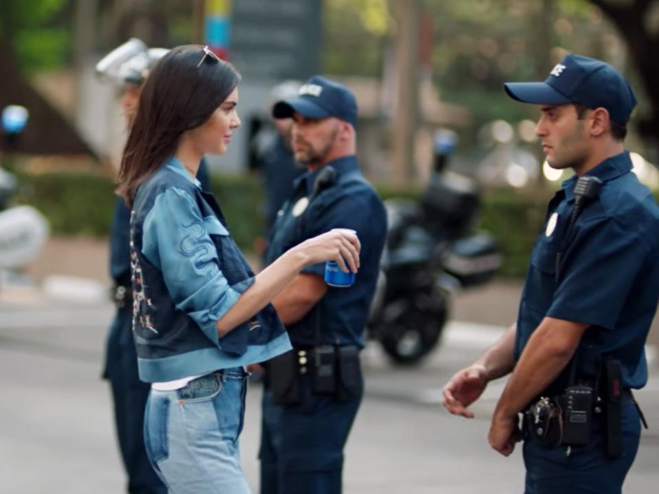 Kendall Jenner with police in a Pepsi ad.