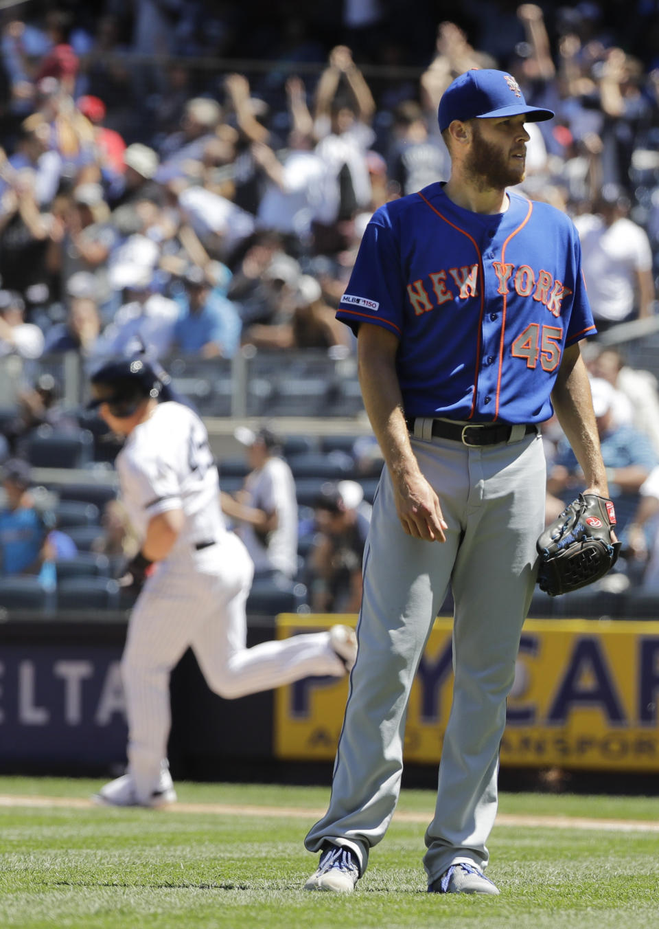 New York Mets starting pitcher Zack Wheeler, right, reacts as New York Yankees' Luke Voit runs the bases after hitting a three-run home run during the fourth inning in the first baseball game of a doubleheader, Tuesday, June 11, 2019, in New York. (AP Photo/Frank Franklin II)