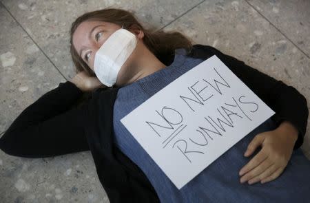 A climate activist from the group Reclaim the Power lies on the ground during a protest against airport expansion plans at Heathrow Airport in London, Britain October 1, 2016. REUTERS/Neil Hall