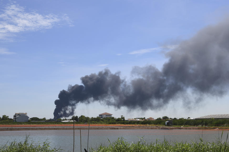 Smoke rises into the air from a factory in Samut Prakan province, Thailand, Monday, July 5, 2021. A massive explosion at the factory on the outskirts of Bangkok early Monday shook an airport terminal serving Thailand's capital and prompted the evacuation of residents from the area. (AP Photo)