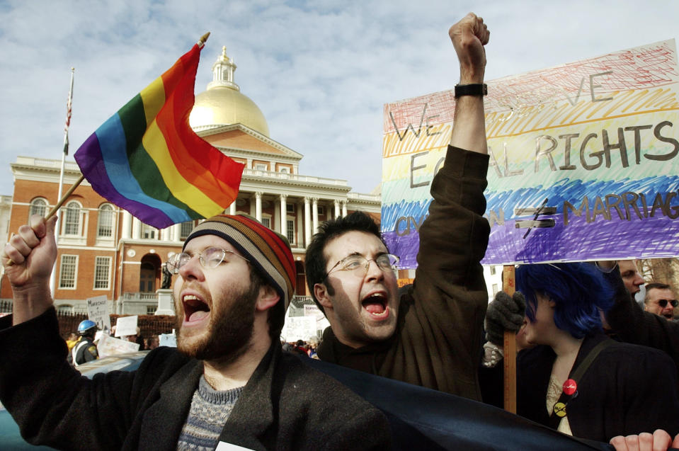 FILE - Demonstrators James Jenner, of Boston, left, and James Murphy, of Cambridge, Mass., center, chant slogans while showing their support for same-sex marriage in front of the Statehouse, in Boston, Thursday, March 11, 2004. Several thousand people on both sides of the same-sex marriage debate gathered in front of the Statehouse Thursday as state legislators debate a constitutional ban on gay marriage. (AP Photo/Steven Senne, File)