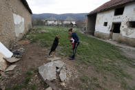 Karmen Bastyur, a 22 year old Hungarian Roma woman, plays with her daughter Fruzsina outside the family home in Bodvaszilas, Hungary, Monday, April 12,2021.Many students from Hungary's Roma minority do not have access to computers or the internet and are struggling to keep up with online education during the pandemic. Surveys show that less than half of Roma families in Hungary have cable and mobile internet and 13% have no internet at all. (AP Photo/Laszlo Balogh)