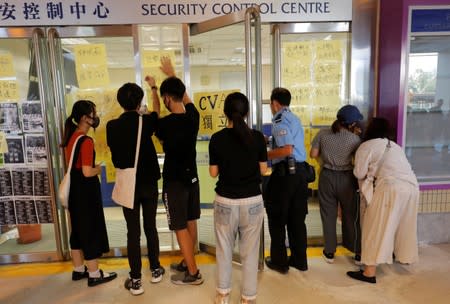 Students at Hong Kong Baptist University take part in a rally after police entered the campus on Sunday while chasing protesters, in Hong Kong