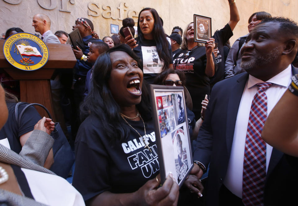 Sequitta Thompson, the grandmother of Stephon Clark, an unarmed vandalism suspect who was shot and killed by two Sacramento police officers last year, celebrates after a measure to limit the police use of deadly force was signed by Gov. Gavin Newsom, in Sacramento, Calif., Monday, Aug. 19, 2019. The bill AB392, by Assmblywoman ShirleyWeber, D-San Diego, would bar police from using lethal force unless it is necessary to prevent imminent threat of death or serious injury to themselves and others. (AP Photo/Rich Pedroncelli)