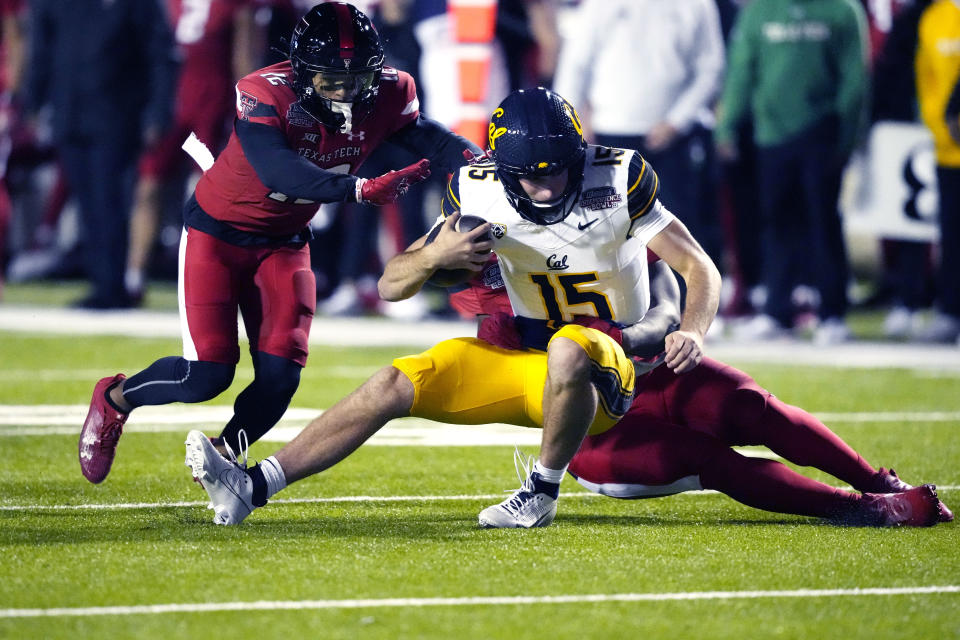 California quarterback Fernando Mendoza (15) is sacked by a Texas Tech defender during the first half of the Independence Bowl NCAA college football game Saturday, Dec. 16, 2023, in Shreveport, La. (AP Photo/Rogelio V. Solis)