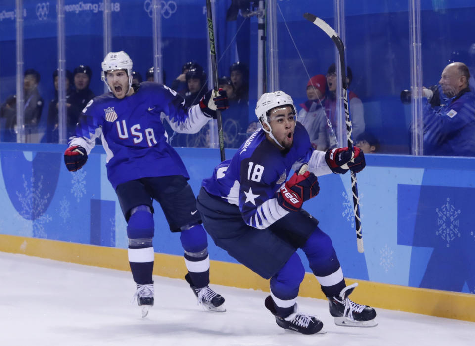 FILE - Jordan Greenway (18), of the United States, celebrates with teammate Bobby Sanguinetti (22) after scoring a goal during the second period of the preliminary round of the men's hockey game against Slovenia at the 2018 Winter Olympics in Gangneung, South Korea, Wednesday, Feb. 14, 2018. USA Hockey and Hockey Canada are eyeing several college players to play at the Olympics after the NHL decided not to participate in Beijing. Anaheim’s Troy Terry, Minnesota’s Jordan Greenway and Seattle’s Ryan Donato played for the U.S. in Pyeongchang. They are major proponents of college players taking the chance, even if it means missing part of the NCAA season. (AP Photo/Frank Franklin II, File)