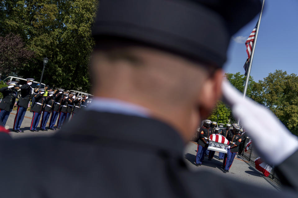 The casket of Sgt. Johanny Rosario Pichardo, a U.S. Marine who was among 13 service members killed in a suicide bombing in Afghanistan, is carried into Veterans Memorial Stadium for a public wake in her hometown of Lawrence, Mass., Tuesday, Sept. 14, 2021. (AP Photo/David Goldman)