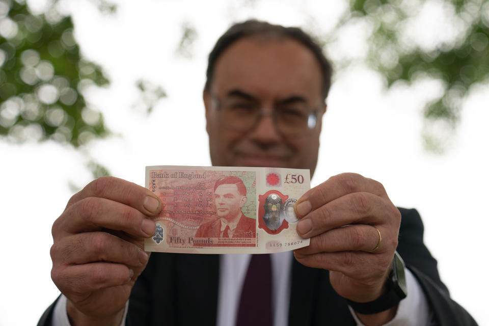 Governor of the Bank of England Andrew Bailey with the new &#x00fffd;50 note which features Alan Turing, at Bletchley Park in Milton Keynes. Picture date: Monday June 21, 2021.