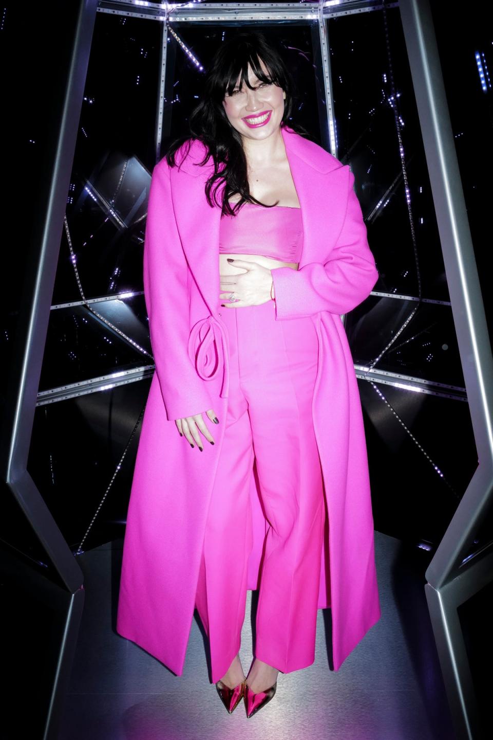 Daisy Lowe stroked her baby bump as she wore an eye-catching pink ensemble to the event (Getty Images for Jimmy Choo)