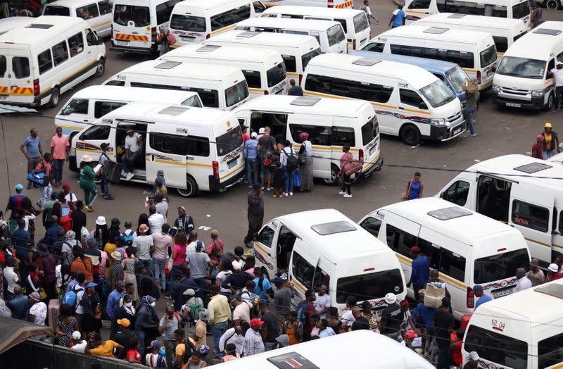 Passengers are seen at at taxi rank as residents of a number of African cities where the coronavirus is spreading are heading to the countryside to try to escape from the disease, in Johannesburg