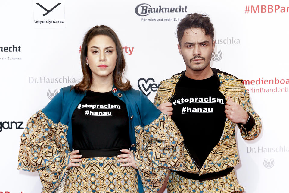 BERLIN, GERMANY - FEBRUARY 22:  German actress Almila Bagriacik and German actor Aram Arami giving attention to the Hanau shooting (#stopracism #hanau) at the Medienboard Party on the occasion of the 70th Berlinale International Film Festival at Ritz Carlton on February 22, 2020 in Berlin, Germany. (Photo by Isa Foltin/Getty Images)