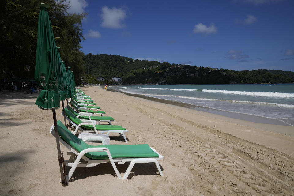 Empty beach chairs line the empty tourist beach of Patong on Phuket, southern Thailand, Monday, June 28, 2021. Thailand's government will begin the "Phuket Sandbox" scheme to bring the tourists back to Phuket starting July 1. Even though coronavirus numbers are again rising around the rest of Thailand and prompting new lockdown measures, officials say there's too much at stake not to forge ahead with the plan to reopen the island to fully-vaccinated travelers. (AP Photo/Sakchai Lalit)