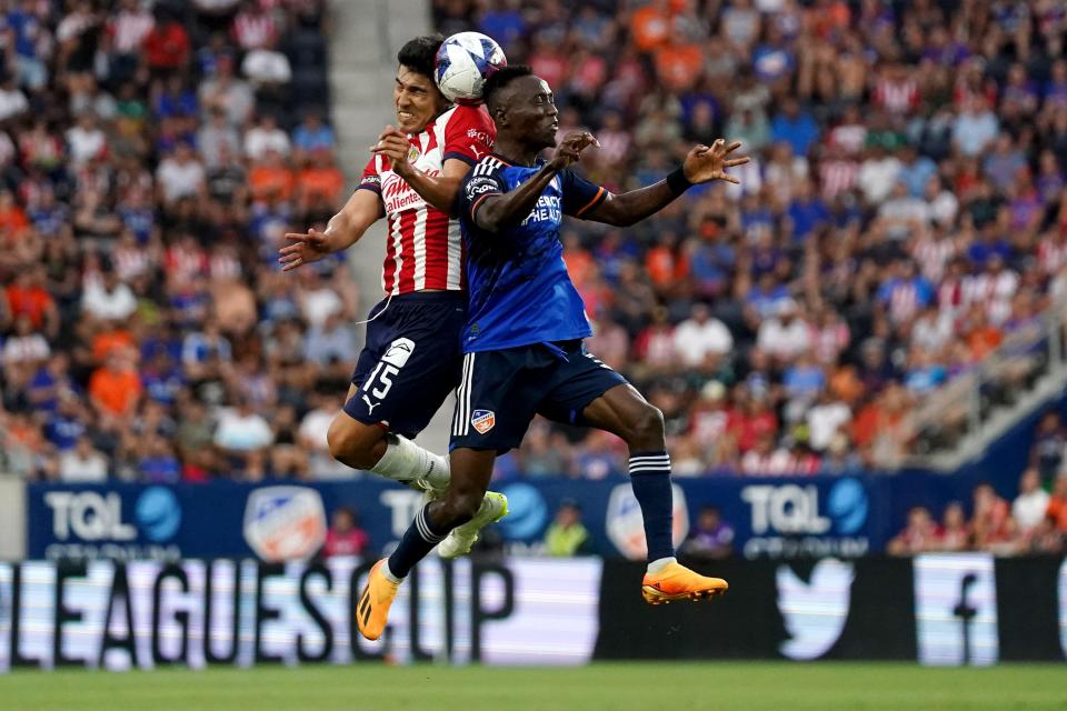 Guadalajara midfielder Erick Gutierrez (15) and FC Cincinnati midfielder Obinna Nwobodo (5) compete for a header in the first half of a Leagues Cup match, Thursday, July 27, 2023, at TQL Stadium in Cincinnati.