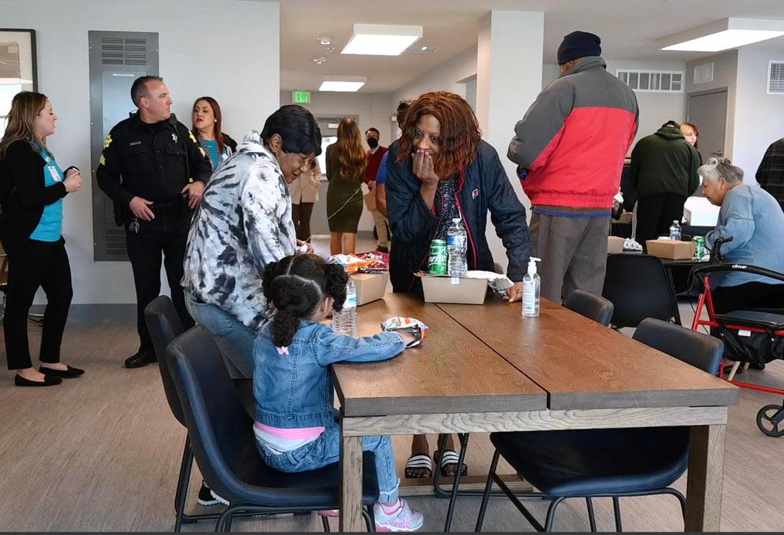 Supporters, including residents of The Link @ Blackstone, gather in the newly opened senior community center to celebrate with food and drinks Monday, Nov. 28, 2022, in Fresno. The center will provide city of Fresno services run by staff for those living at The Link @ Blackstone as well as the surrounding community, including computer classes, fitness and dance, arts and a place to gather socially.