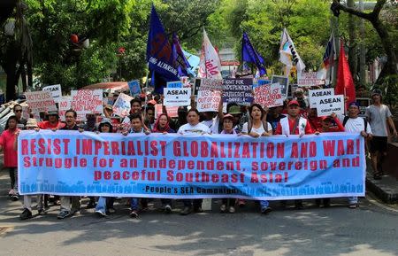 Demonstrators display a banner as they march towards the Philippine International Convention Center, which is the venue of the Association of Southeast Asian Nations (ASEAN) Summit in metro Manila, Philippines April 29, 2017. REUTERS/Romeo Ranoco