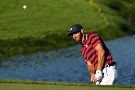 Dustin Johnson of the United States chips on the 17th hole during the afternoon four-ball matches in the 41st Ryder Cup at Hazeltine National Golf Club. Mandatory Credit: John David Mercer-USA TODAY Sports