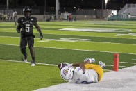 As Hawaii defensive back Khoury Bethley (5) looks on, San Jose State wide receiver Isaiah Hamilton (9) pulls in a touchdown pass during the first half of an NCAA college football game, Saturday, Sept. 18, 2021, in Honolulu. (AP Photo/Marco Garcia)