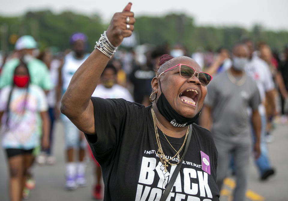 Celeste Taylor chants as she leads demonstrators on Halstead Avenue in Elizabeth City, N.C., Thursday, April 29, 2021. This is the ninth day of demonstrations in the wake of Andrew Brown Jr.'s death at the hands of Pasquotank County deputies. (Robert Willett/The News & Observer via AP)