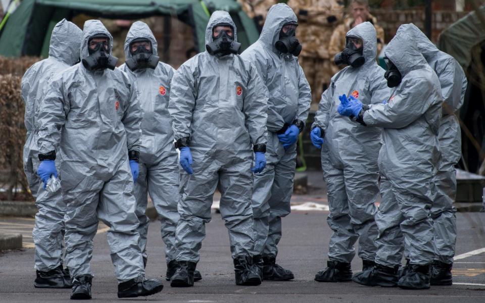 Military personnel wearing protective suits at work in Salisbury last month after the nerve agent attack  - Getty Images Europe