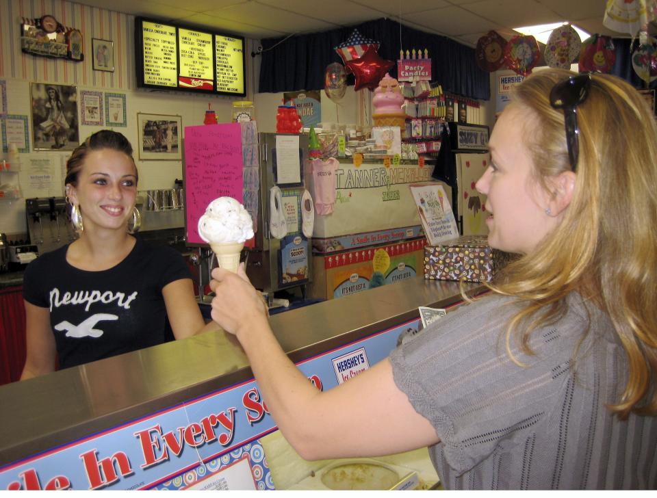 Krista Ladd (left) dishes ice cream to customer Colleen Watson (right) at Suzy-Q's at 1110 Chenango Street in 2009.