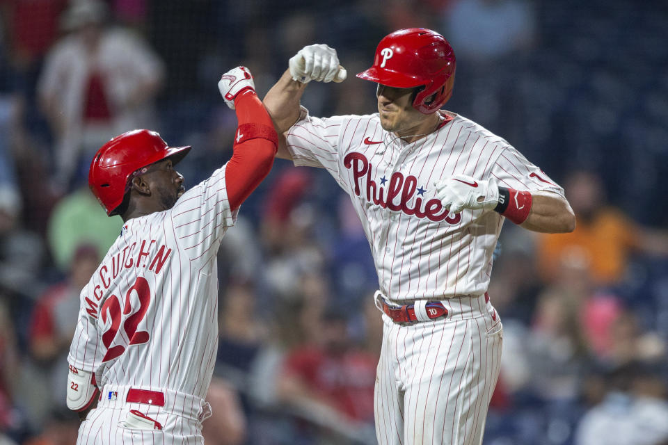 Philadelphia Phillies' J.T. Realmuto celebrates with Andrew McCutchen (22) after Realmuto hit a home run during the sixth inning of the team's baseball game against the Atlanta Braves, Tuesday, June 8, 2021, in Philadelphia. (AP Photo/Laurence Kesterson)