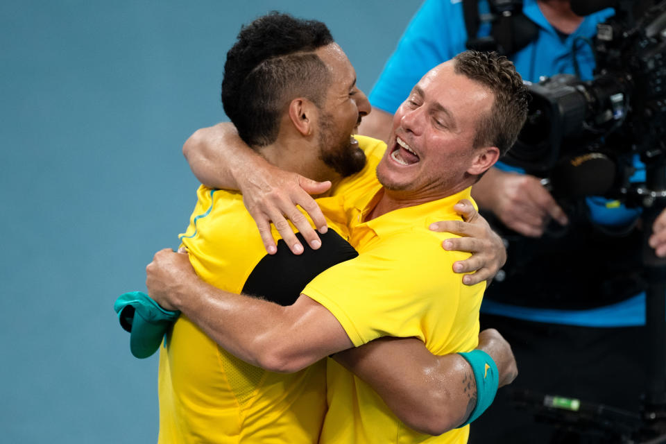 Pictured left to right, Nick Kyrgios and Australia's Davis Cup captain Lleyton Hewitt share an on-court hug.