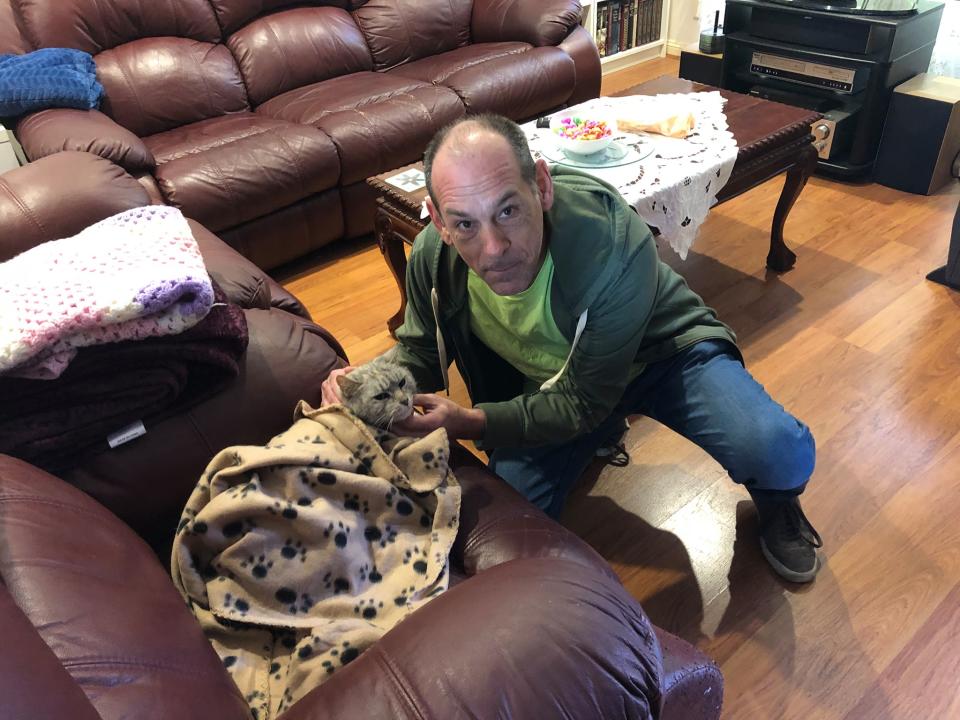 Polar the cat who was missing for three years pictured with Fabian Salamon. Source: Community Cat Carers