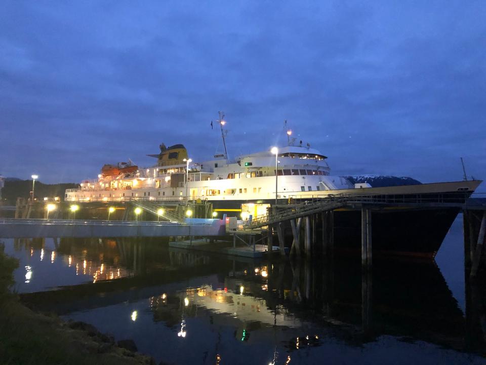 A ferry cruise ship in dock at night.