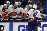 New York Islanders defenseman Ryan Pulock (6) celebrates with the bench after scoring against the Tampa Bay Lightning during the third period in Game 1 of an NHL hockey Stanley Cup semifinal playoff series Sunday, June 13, 2021, in Tampa, Fla. (AP Photo/Chris O'Meara)