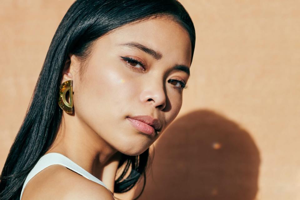 Close-Up Portrait Of A Beautiful Young Woman During Golden Hour